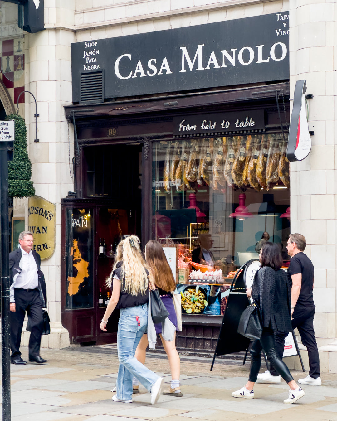 The Casa Manolo storefront at 99 Strand, with Jamón Ibérico displayed in the window