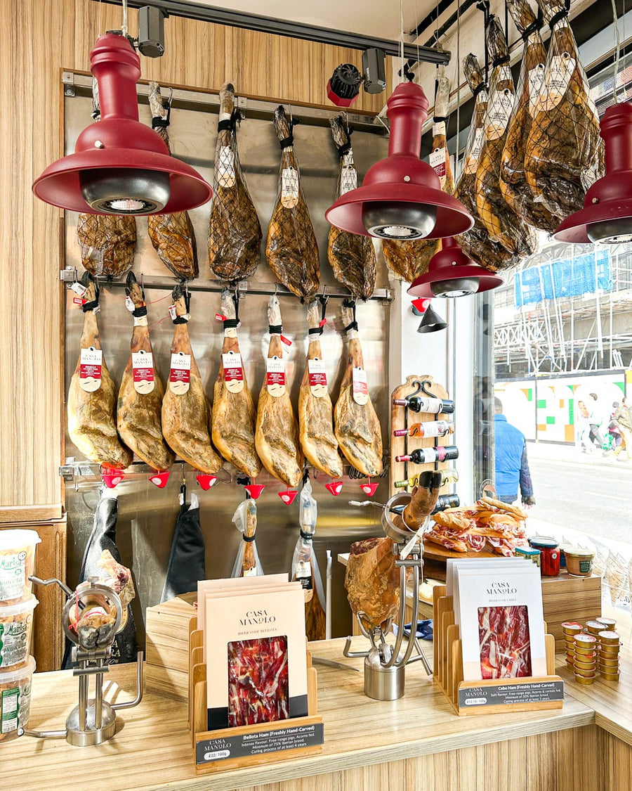 Jamón Ibérico displayed at a Casa Manolo deli counter
