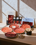Iberico Bellota set featuring a variety of cured meats with artisan breadsticks, showcasing premium quality and flavors.