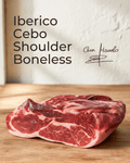 Iberico Cebo Shoulder — Boneless displayed on a wooden surface, showcasing its rich marbling and tender texture.