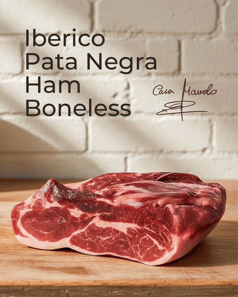 Iberico Pata Negra Ham — Boneless displayed on a wooden board with a signature in the corner.