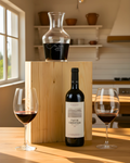Pago de Carraovejas Wine Box featuring a bottle, decanter, and wine glasses in a cozy kitchen setting.