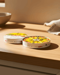 Quince Paste Membrillo packaging displayed on a wooden countertop, showcasing its traditional design and vibrant fruit graphics.